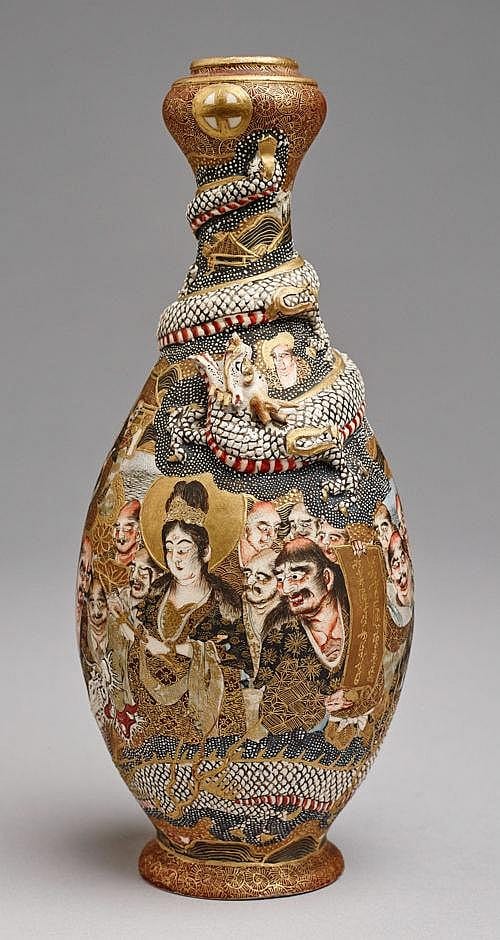 Tall ceramic Satsuma-style vase with a gold and dark blue banded neck and painted scenes of figures and animals around the body.