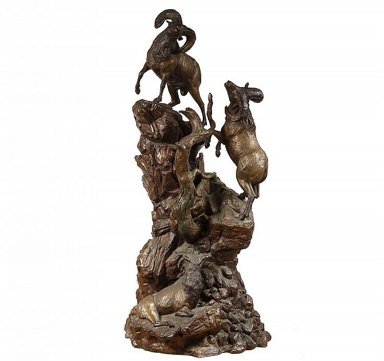 Bronze figurative sculpture group of animals and people standing and climbing on a rocky base, viewed from the front.