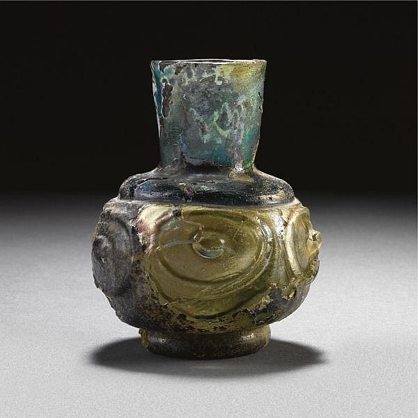 A rare two-colour glass bottle with moulded decoration, probably EGYPT, 9TH-11TH CENTURY sold by Sotheby's, lot 67 — auction record photograph
