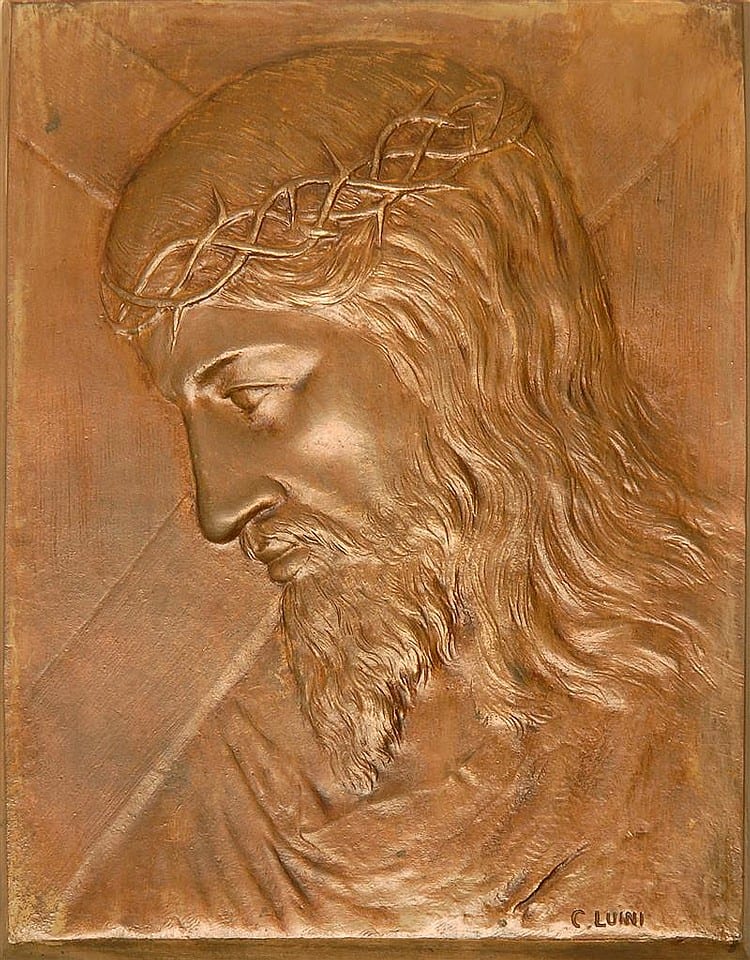 Bronze bas-relief plaque showing the side profile head of Christ with a crown of thorns and long wavy hair.