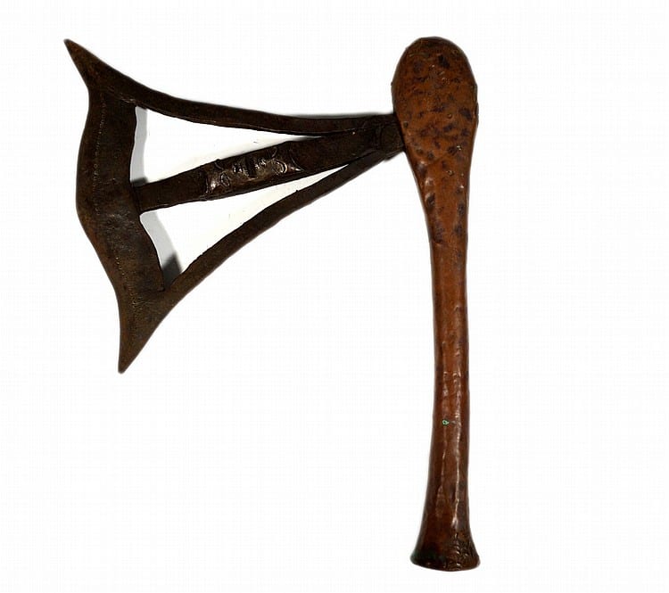 Iron axe head with a triangular blade, attached to a long wooden handle, photographed against a white background.