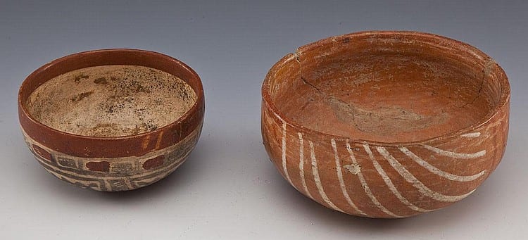 Two small terracotta pottery bowls with painted geometric designs, shown from above on a neutral background.