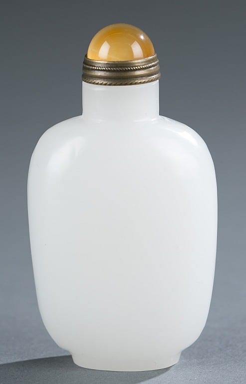 White snuff bottle with a rounded body, capped top, and a narrow neck with a metal collar against a gray background.