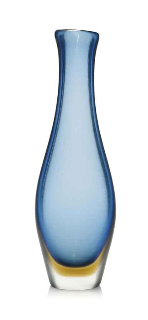 Blue and clear glass vase with a narrow neck and flared rim on a white background.