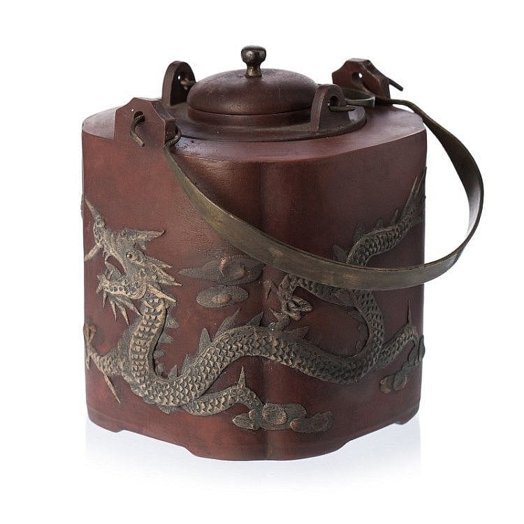 Brown ceramic teapot with a domed lid, short spout, and a dragon relief motif around the body and lid top.