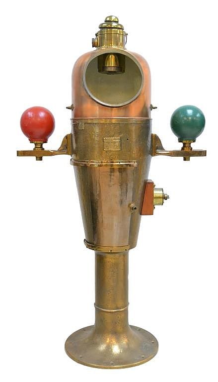 Brass ship binnacle with a clear dome top and two mounted globes—one red and one green—on either side.