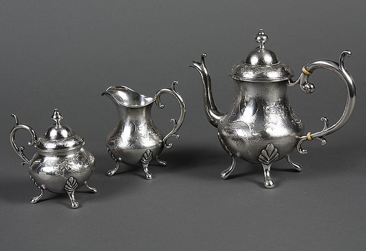 CHINESE EXPORT SILVER TEA SET - Three piece tea set on four slipper feet. Baluster body, hammered finish, hand-chased dragon on each... sold by Pacific Galleries, lot 209B — auction record photograph