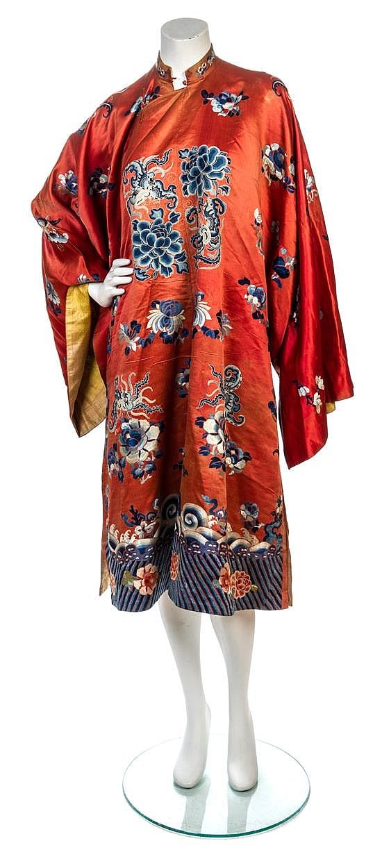Orange kimono on a mannequin display, with blue floral and dragon-style motifs and long sleeves