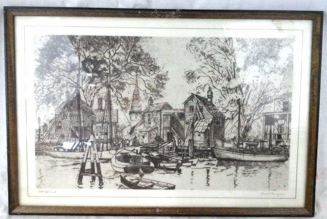 Framed black-and-white print showing a riverside scene with boats, a dock, and buildings in the background.