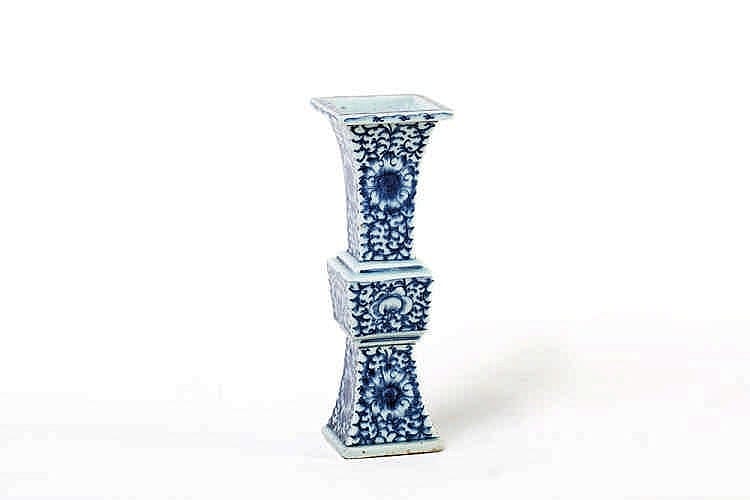 White and blue porcelain vase with a narrow neck and flared lip, decorated with repeating floral and scroll patterns.
