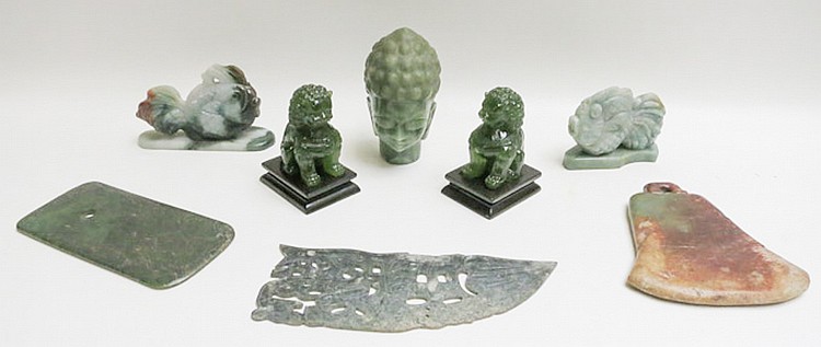 EIGHT CHINESE CARVINGS, pair of jade fish on applied matching bases, inkstone in the shape of a bell made of serentine, pair of tremolite (sepentine) foo lions, flat jade inkstone 3 1/4" by 6 3/4", quan yin head carved from green pagodite and a sold by O'Gallerie, lot 386 — auction record photograph