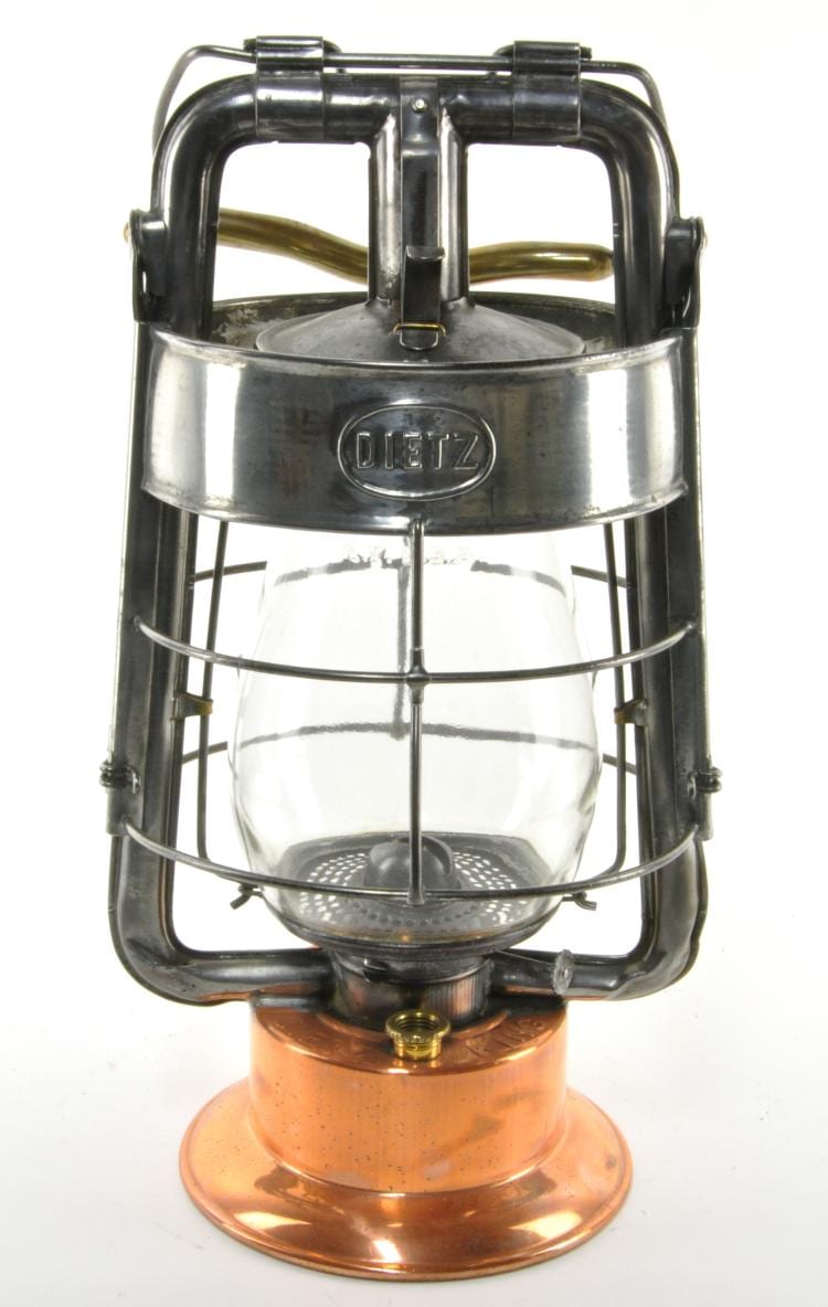 Metal fire lantern with a glass globe and circular burner base, branded “DIETZ” on the top frame.