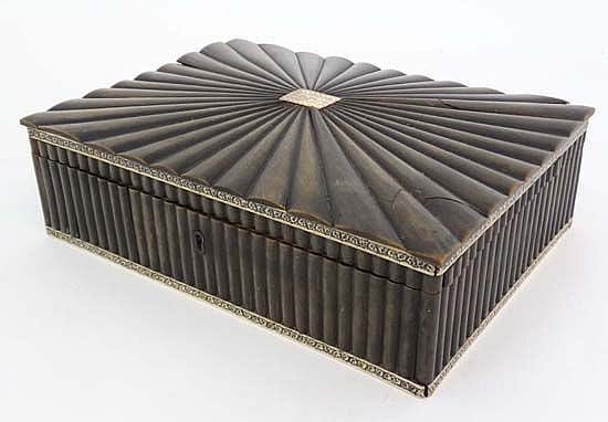 Rectangular hinged sewing box or casket with a black ribbed exterior, decorative brass trim, and a domed lid with ridged pattern.