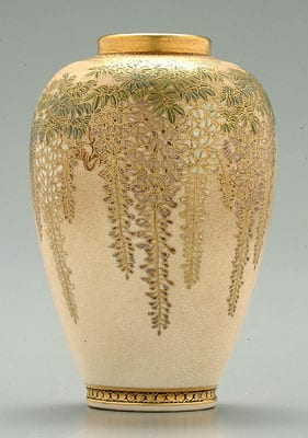 Cream ceramic vase with a gold patterned floral and foliage design cascading down the front and a small round rim