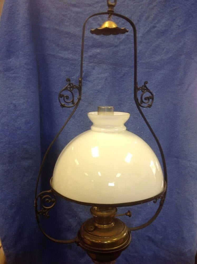 A Victorian oil lamp with milk glass shade above a sold by Railtons, lot 335 — auction record photograph
