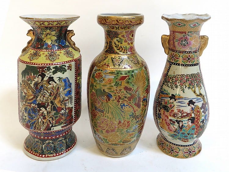 Three Japanese-style baluster vases with painted scenes, floral bands, and gold accents on a white background.