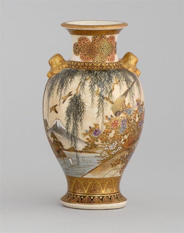 Baluster-form ceramic vase with gold rim, sculpted handles, and painted scenes of pine trees, birds, and flowers on a light background.