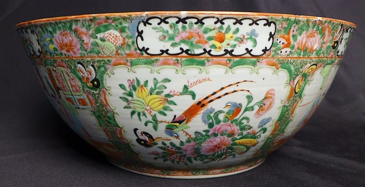 Decorative ceramic punch bowl with colorful floral medallion pattern and orange rim trim.