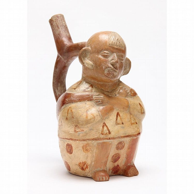 Terracotta stirrup vessel shaped like a seated human figure with painted geometric patterns, shown upright on a white background.