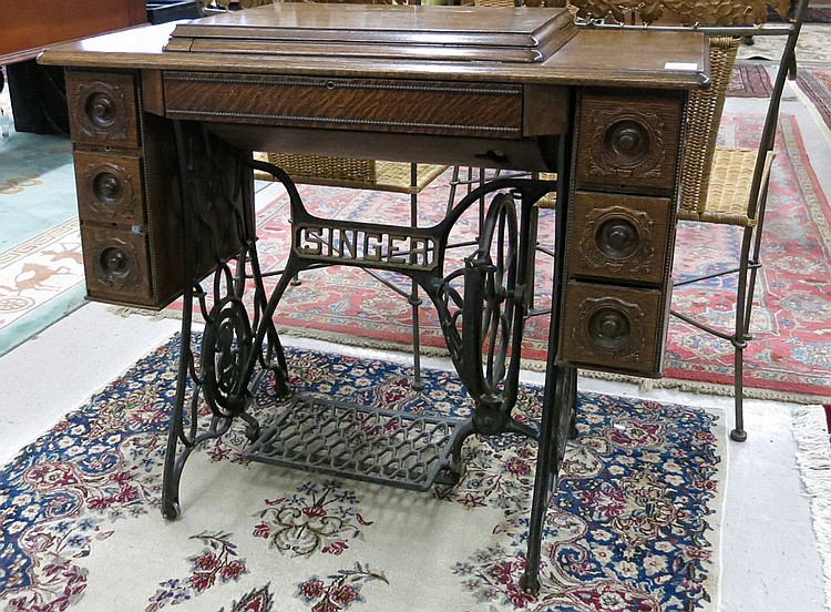 AN OAK CABINET TREADLE SEWING MACHINE, The Singer sold by O'Gallerie, lot 591 — auction record photograph