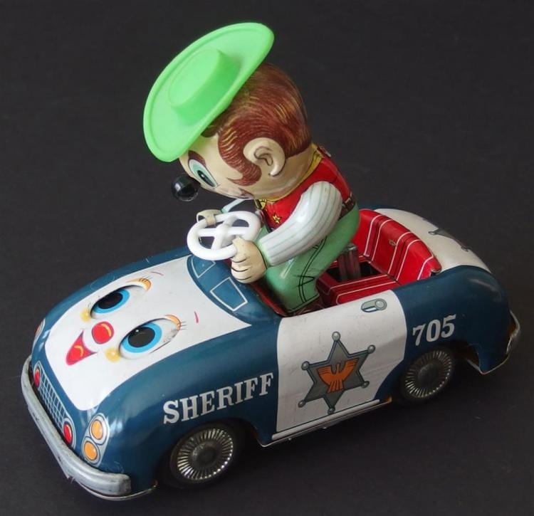 Vintage tin toy car with a cartoon sheriff character and open green top, painted in blue and white with the number 705 on a black background.