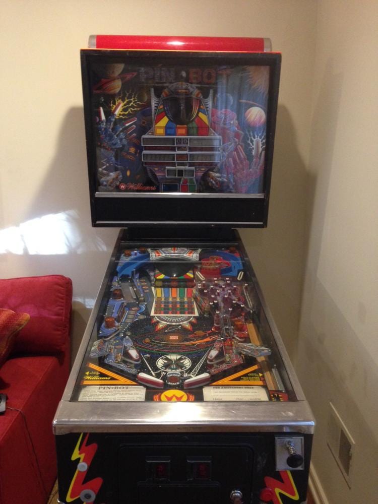 Vintage pinball machine with colorful playfield and backglass featuring the text “PIN BO” and arcade-style artwork.