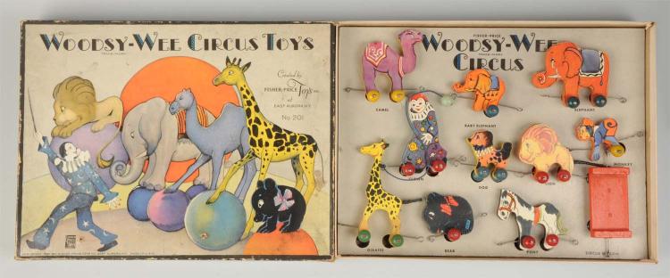 Boxed Fisher-Price “Woodsy-Wee Circus Toys” set with painted circus animals and pieces arranged inside.