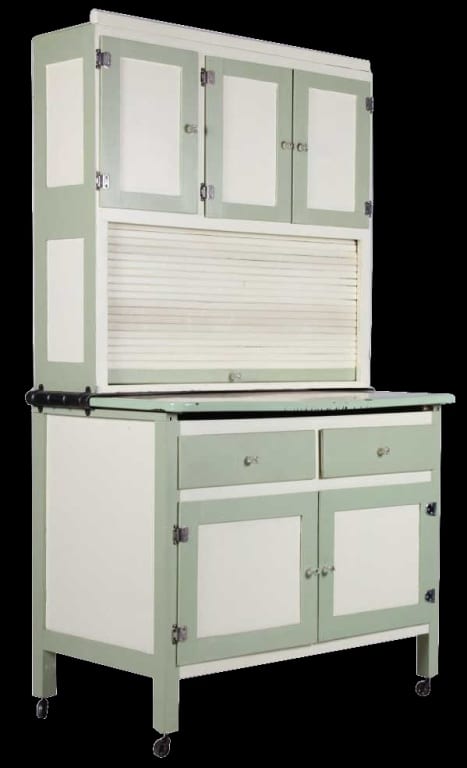 Light green vintage kitchen cabinet with multiple doors, drawers, and a raised countertop, shown front view.