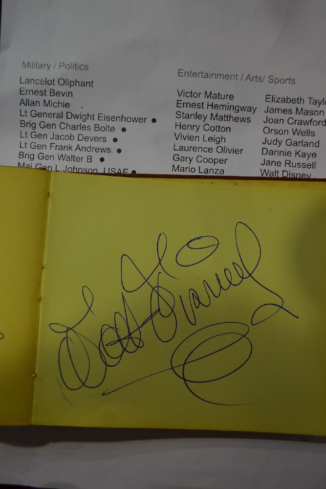 Rare Autograph book compiled by Harold Fuhrmann (b.1900-1958/59) the head waiter of the prestigious Savoy Hotel, London to include the signatures of Walt Disney, Victor Mature, Ernest Hemingway, Stanley Matthews, Henry Cotton, Vivien Leigh, Laurence Olivier, Gary Cooper, Mario Lanza, Dana Andrews, Deborah Kerr, Gracie Fields, Alan Ladd, Wickham Steed, Peggy Cummins, Greer Garson, Elizabeth Taylor, James Mason, Joan Crawford, Orson Wells, Judy Garland, Dannie Kaye, Jane Russell, Gregory Peck, Michael Todd, Michael Wilding, Bob Hope, Cecil Mills, Jayne Mansfield, Lancelot Oliphant, Ernest Bevin, Allan Michie, Dwight Eisenhower, Charles Bolte, Jacob Devers, Frank Andrews, Brig Gen Walter B, Major General L.Johnson USAF, Hoyts Vanderberg, Charles Lindberg, Colonel P Youngs, Halifax, Samuel Hoare, Archibald Wavell, Anthony Eden, Archibald Sinclair, John Anderson, Randolph Churchill, Malcolm McDonald, Lord/ Lady Beveridge, Baldwin of Beudley, Pamela Churchill, Khaled Desal, Abdallah AI-Fesial, Rainer, Hussien of Jordan & more sold by Vickers & Hoad, lot 264 — auction record photograph