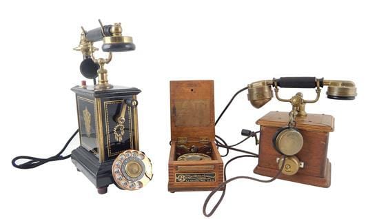 Two vintage tabletop crank telephones and a rotary-dial telephone shown side by side on a white background.
