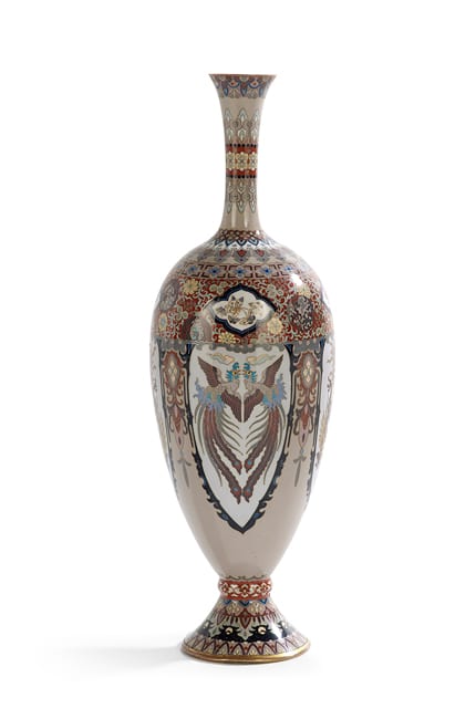 Amphora-shaped cloisonné vase with multicolor floral and bird-like medallion designs and a flared neck on a white background.