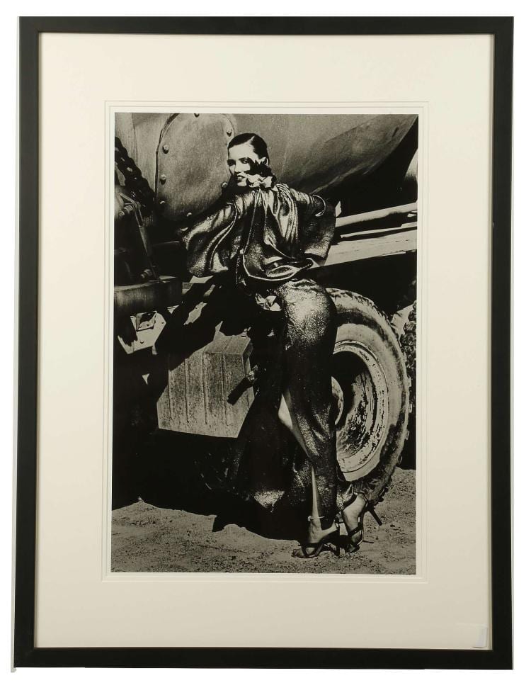 HELMUT NEWTON (GERMAN 1920-2004), Truck Stop, silver gelatin print, printed by Helmut Newton Studio pre-1985, certificate of authenticity present, (51 x 41 cm, image; 69 x 58 cm, framed), edition of 6.  (MAY BE SUBJECT TO ARTIST'S RESALE RIGHTS) Condition: Stored in conservation environment.  Provenance: This collection of vintage prints was gifted to Helmut Newtons agent Norman Solomon, in recognition of the work he had carried out in promoting Newtons Private Property series of exhibitions in 1985.   All photographs in this collection are rare vintage prints shot and produced in strictly limited edition from a series of transparencies before 1985. Always unsigned, they were sent to major publications to stimulate interest in the photographers work; most of these type of prints were destroyed or written over.  Notes: Truck Stop reflects Helmut Newtons early years as a truck driver in the Australian army. It is one of few rare images that features this motif and directly relates back to his early years in Melbourne, providing an intimate insight into Newtons personal fantasies. Expertly manipulating light, Newton transforms the model in an almost abstract conception of oil spilling out of the truck. sold by Chiswick Auctions, lot 15 — auction record photograph
