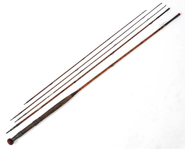 Long split-cane fishing rod with three brown sections and black tips, photographed on a plain white background.