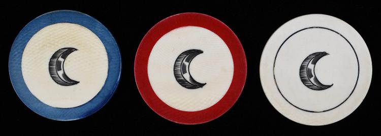 Three crescent-shaped scrimshaw poker chips with black crescent designs on blue, red, and white rims.