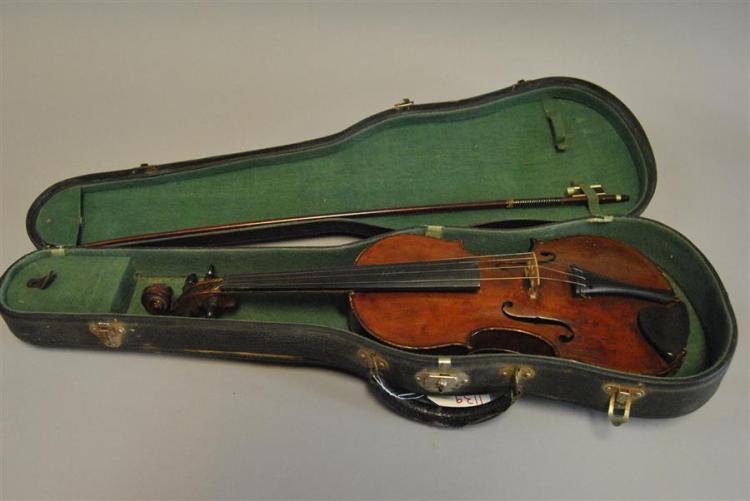 Brown violin resting inside a green hard case with a bow laid alongside.