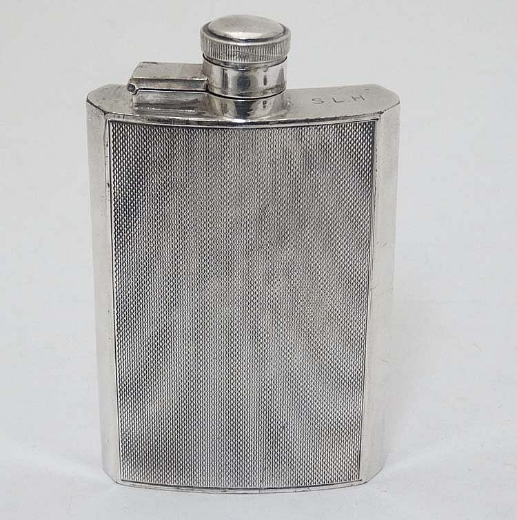 Abd al-Hadi al-Gazzar comparable auction result: a silver plate hip flask of shaped form with engine turned decoration by ja