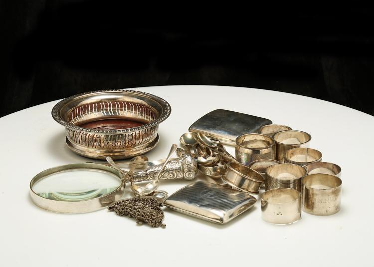 A mixed group of antique sterling silver items, including a cased pair of George V sauceboats, Sheffield 1936, by E Viners With loop handle and shaped rim,  length 14.5 cm/5.7 inches, a Elizabeth II wine coaster, Birmingham 1993, by Barker Ellis Silver Co, with pierced band, slant gadroon rim and turned wood base, diameter 14.5 cm/5.7 inches, an Edwardien silver-handled magnifier, London 1902, a continental cigarette case, with import marks for London 1897, another cigarette case, Birmingham 1918, a set of six coffee spoons, Sheffield 1964, by E Viners, three coffee spoons Sheffield 1925, three paris of sugar tongs, ten late 19th/early 20th century napkin rings, two souvenir spoons, a condiment spoon, a bright-engraved dessert forks and a small purse. (Qty) Weight of weighable silver – 946 grams/30.4 ozt £200-300 sold by Chiswick Auctions, lot 89 — auction record photograph