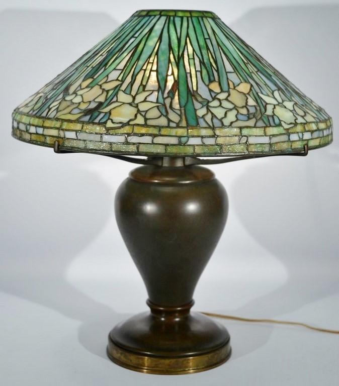 Auction comp thumbnail for Tiffany Studios Daffodil table lamp having leaded Favrile glass shade with cascading daffodils on bronze oil converted to electric b... (Nadeau's Auction Gallery, Lot 350)