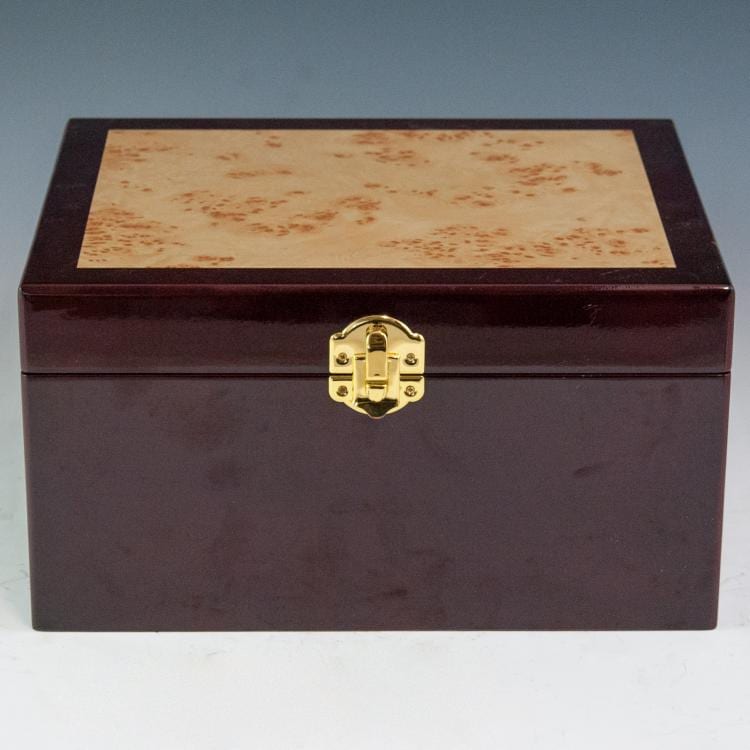 Closed dark wooden cigar box with gold-toned clasp and a rectangular inlaid lid panel.