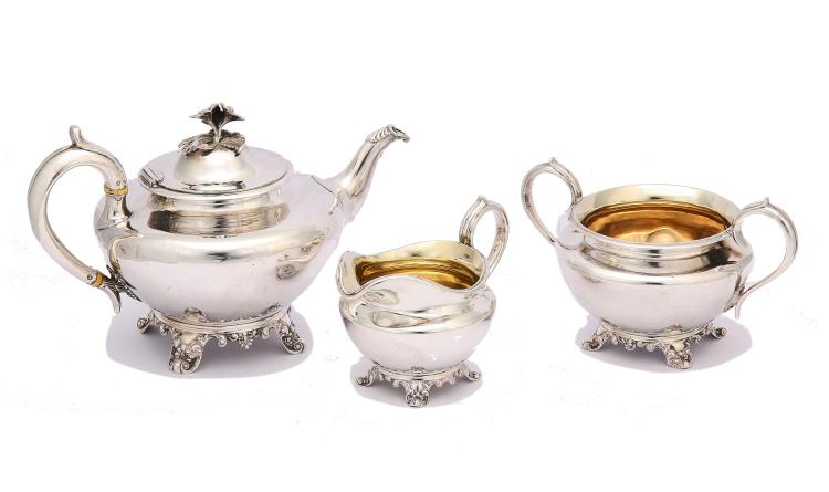 An early Victorian antique sterling silver three-piece tea service, London 1839, by John Angell II & George Angell Of compressed circular form, the teapot with ivory insulators, the domed hinged cover with flower finial, the sugar bowl and cream jug with gilt interior, raised on shell-embellished feet. (3) Length of teapot – 29 cm/11.4 inches Weight – 1380 grams/44.3 ozt sold by Chiswick Auctions, lot 293 — auction record photograph