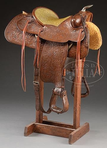 TOOLED WESTERN ROPING SADDLE MADE BY NUDIE'S RODEO TAILORS OF NORTH HOLLYWOOD, CALIFORNIA, ESPECIALLY FOR JOHN WAYNE. sold by James D. Julia, lot 2134 — auction record photograph