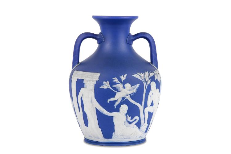 A WEDGWOOD MODEL OF THE PORTLAND VASE, late 19th century, after the Roman original, decorated with nude and semi-nude classical figures moulded in relief against a blue jasper dip ground, probably depicting the myth of Peleus and Thetis, the basal disc with a portrait figure wearing the Phrygian cap, said to depict Paris, 26.5cm high, impressed 'WEDGWOOD' with date code 'THP' for 1861 or 1887 FOOTNOTES: The original Roman cameo glass Portland vase, now in the British Museum (accession no. 1945,0927.1), is thought to have been made in the first quarter of the 1st century AD in Rome. Originally of amphora shape, the base has been broken and replaced by a disc of a slightly later date and different colour. The vase is regarded as a masterpiece of classical art. Said to have been discovered in a marble sarcophagus in a tomb near Rome in 1582, it was bought by Cardinal Franceso Barberini in 1626, remaining in the Barberini family until 1780. Then it was then sold to James Byres, the Scottish antiquary, passing via Sir William Hamilton to the Dowager Duchess of Portland in 1784. In 1786 it was sold as part of her 'Museum of Antiquities' to the third Duke of Portland. It was at this point that the vase was borrowed by Josiah Wedgwood with the aim of copying it, prompted by John Flaxman. Josiah, his son Josiah II, Henry Webber and William Hackwood, worked for four years on the reproduction, overcoming huge technical problems to produce the first successful vase in 1790. It continued to be reproduced in jasper ware widely into the 19th and 20th centuries. sold by Chiswick Auctions, lot 22 — auction record photograph
