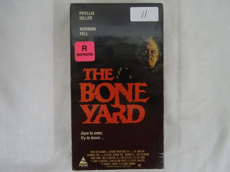 Front cover of a vintage horror VHS tape case titled “The Bone Yard,” with a red warning label and a monster face graphic.
