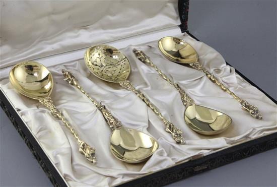 A cased set of four Victorian silver gilt "apostle" serving spoons and matching sifter spoon by Robert Harper, 7.5 oz. sold by Gorringes, lot 743 — auction record photograph
