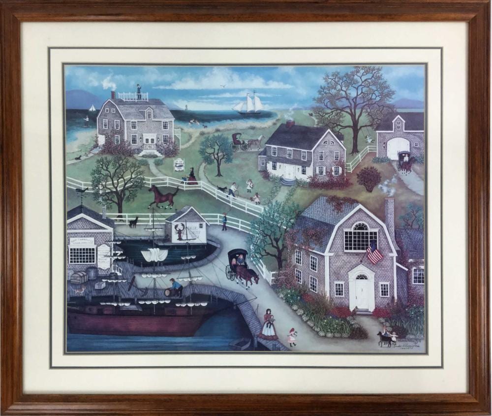 Framed colorful print of a Cape Cod style coastal village with houses, a horse, people walking along a path, and sailboats in the distance.