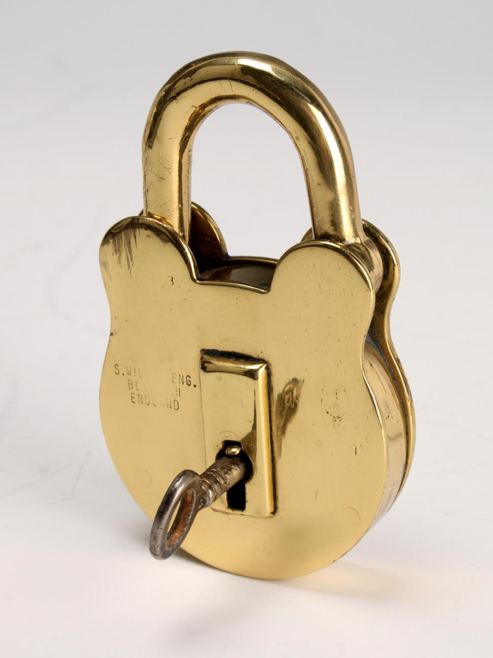 Antique brass padlock with arched shackle and keyhole, shown front view on a light background.