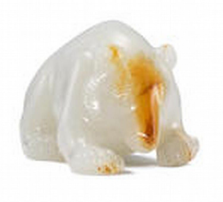 An exceedingly rare and important white and russet jade carving of a bear Western Han Dynasty comparable sale