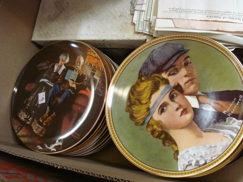 Two decorative collector plates with painted scenes, including a portrait of a woman in a hat on a green background.