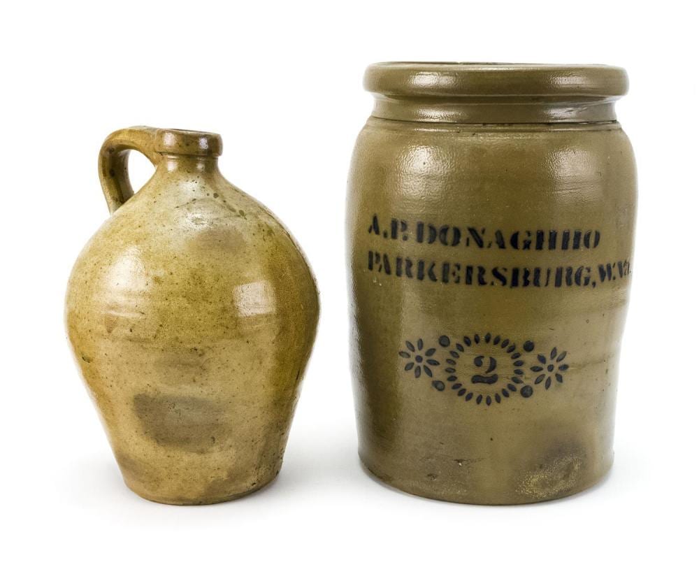 TWO PIECES OF STONEWARE A two-gallon crock with sunburst decoration and cobalt blue lettering "A.P. Donaghho Parkersburg, W. VA", he... sold by Eldred's, lot 382 — auction record photograph