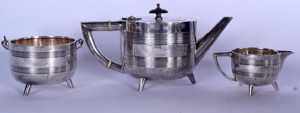 Three-piece silver-plated tea service with a teapot in the center and a sugar bowl and cream jug on either side.